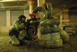 Indoor Paintball Manchester man crouching down