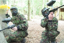 Paintball players with a smoke grenade